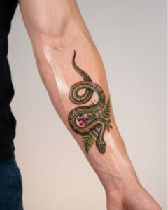 Colorful Snake with Fern and Berries Arm Tattoo Design Inkbulb