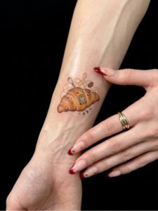 Croissant Arm Hand Tattoo Design Inkbulb